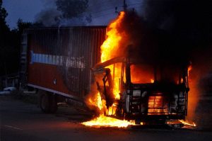 Amas: Maoists set ablaze a vehicle at GT Road during their Jharkhand bandh, in Amas on Monday